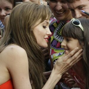 Pure magic ignites as Angelina Jolie embraces a young fan at the premiere of Salt in Russia. A heartwarming connection that will last forever.