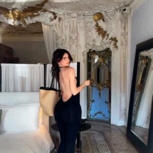 Kylie Jenner stuns in a sleek black catsuit from her own brand, revealing a daring bare back look. Kylie Jenner stuns in a sleek black catsuit from her own brand, revealing a daring bare back look.